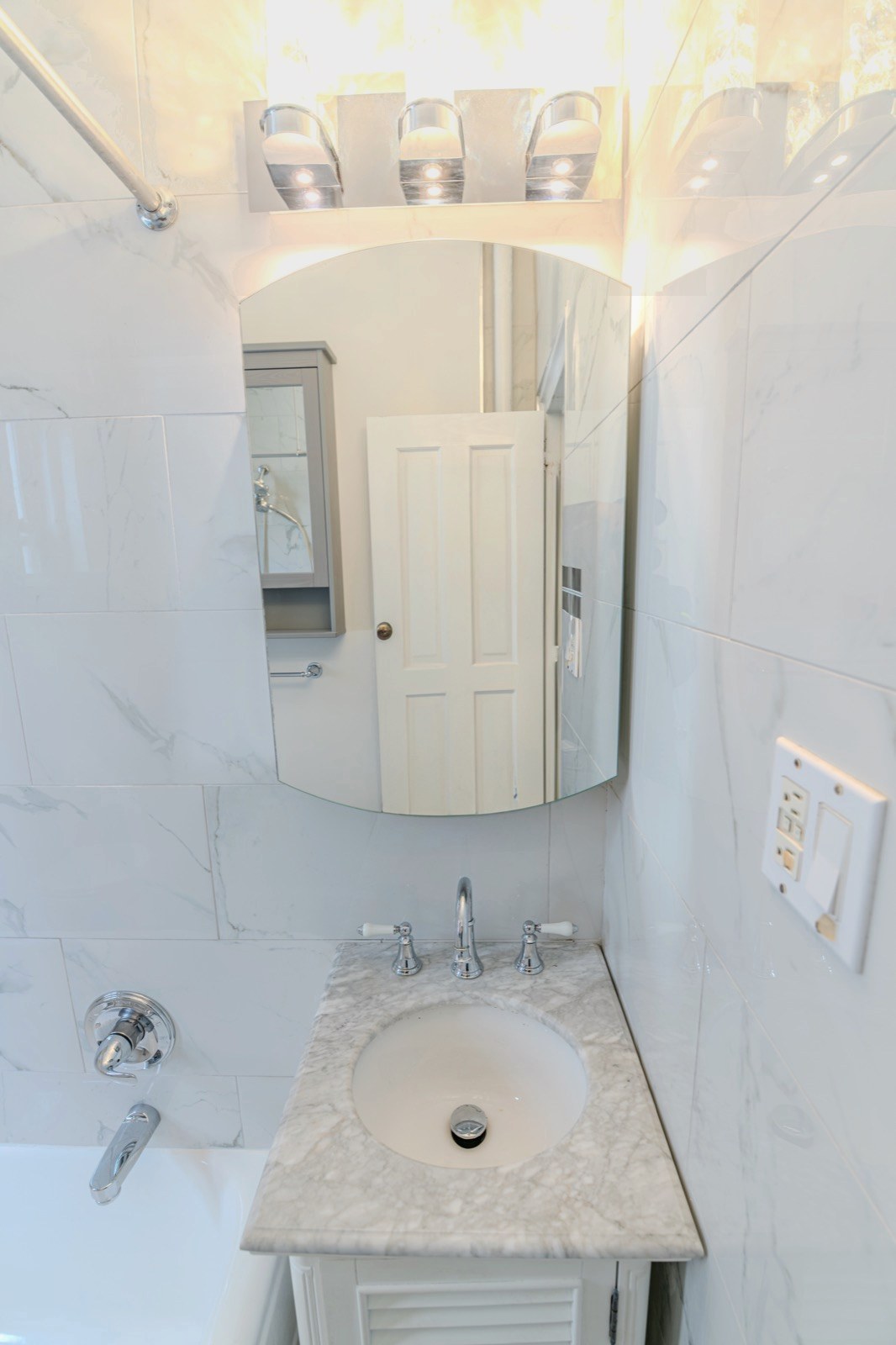 Marble bathroom vanity with soft ambient lighting and material detail